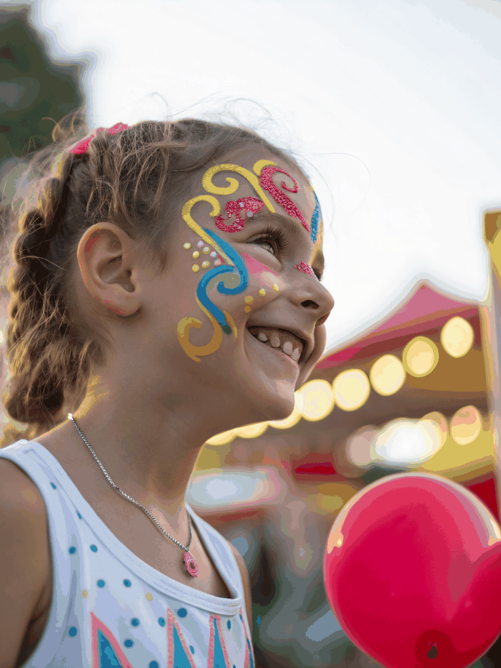 Joyful child with vibrant floral and butterfly face paint
